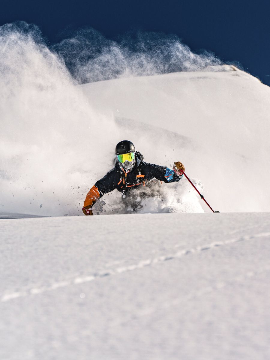 Skier in deep powder wearing House of Hygge