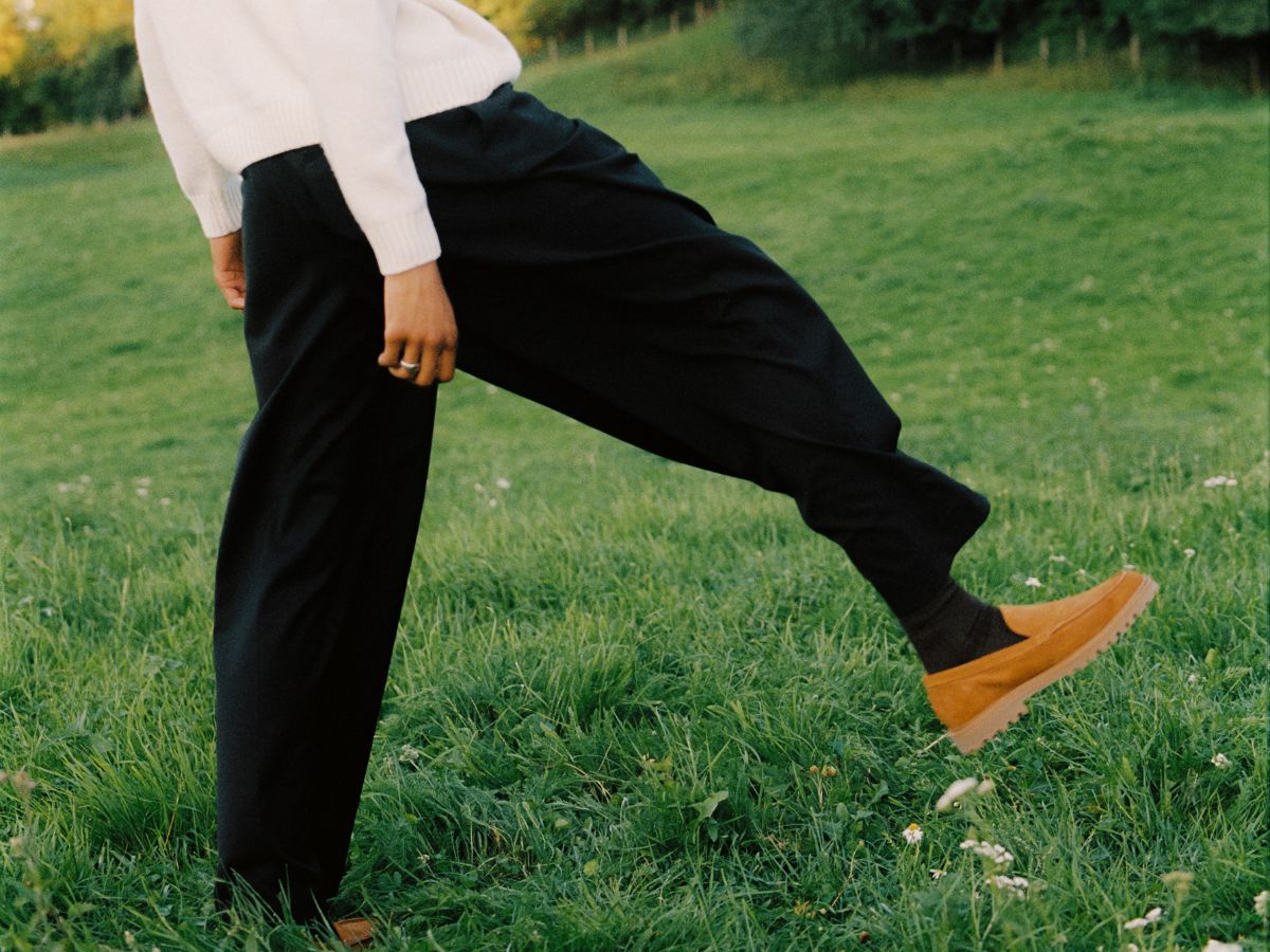 New Movements cognac loafer, mid-kick in a meadow